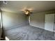 Spacious primary bedroom with neutral walls, ceiling fan, and entry to main bathroom at 111 Coharie Dr, Lillington, NC 27546