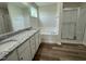 Luxurious bathroom with dual sinks, granite counters, a soaking tub, and a separate shower at 111 Mahogany Way, Four Oaks, NC 27524