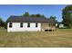 Exterior of home shows back porch, white siding, black roof, and lush grassy backyard at 111 Mahogany Way, Four Oaks, NC 27524