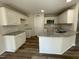 Modern kitchen features white cabinets, granite countertops, and stainless steel appliances at 111 Mahogany Way, Four Oaks, NC 27524