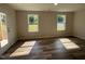 Inviting living space with hardwood floors and natural light coming from two big windows at 111 Mahogany Way, Four Oaks, NC 27524
