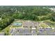 An aerial view of a tennis court, a large parking lot and a recreation center with a pond in the background at 1112 Monterey Bay Dr, Wake Forest, NC 27587