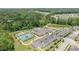 A high angle shot shows a large parking lot, tennis courts, and an amenities building surrounded by lush greenery at 1112 Monterey Bay Dr, Wake Forest, NC 27587