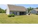 Well-maintained backyard features a screened porch and manicured lawn, perfect for outdoor gatherings at 1112 Monterey Bay Dr, Wake Forest, NC 27587
