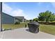 Backyard with well-manicured lawn, a concrete patio, and a covered grill at 1112 Monterey Bay Dr, Wake Forest, NC 27587