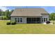 Well-maintained backyard features a screened porch and manicured lawn, perfect for outdoor gatherings at 1112 Monterey Bay Dr, Wake Forest, NC 27587