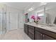 Bathroom with double vanity, granite counters, and an elegant orchid centerpiece at 1112 Monterey Bay Dr, Wake Forest, NC 27587