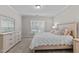 Bedroom featuring a queen bed, carpet flooring, and a large window at 1112 Monterey Bay Dr, Wake Forest, NC 27587
