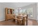 A dining room with wood table and seating with natural light and wood floors at 1112 Monterey Bay Dr, Wake Forest, NC 27587