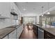 Long kitchen with island, granite counters, and view looking into the dining room at 1112 Monterey Bay Dr, Wake Forest, NC 27587