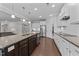 Bright kitchen featuring a large island with seating, stainless steel appliances, granite counters, and white cabinets at 1112 Monterey Bay Dr, Wake Forest, NC 27587