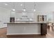 Bright, white kitchen with island, hardwood floors, and pendant lighting at 1112 Monterey Bay Dr, Wake Forest, NC 27587