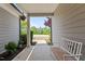 Covered porch with bench and decor invites relaxation and provides neighborhood views at 1112 Monterey Bay Dr, Wake Forest, NC 27587