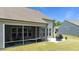 Exterior shot of screened porch with outdoor seating and grill, next to manicured lawn at 1112 Monterey Bay Dr, Wake Forest, NC 27587