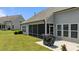 Exterior of screened porch with a covered grill and well-maintained lawn at 1112 Monterey Bay Dr, Wake Forest, NC 27587