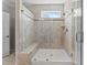 Shower with showerhead, bench, and mosaic tile at 1112 Monterey Bay Dr, Wake Forest, NC 27587