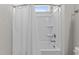 Standard bathtub and shower combination with a white shower curtain at 1112 Monterey Bay Dr, Wake Forest, NC 27587