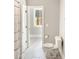 Bathroom featuring a toilet, tile floors, and a view to the hallway and shower area at 1218 Rogers Farm Rd, Wake Forest, NC 27587