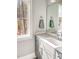 Clean bathroom features a light gray vanity, large mirror, and a view of the trees at 1218 Rogers Farm Rd, Wake Forest, NC 27587