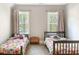 ' bedroom featuring two twin beds with colorful bedding and natural light from two windows at 1218 Rogers Farm Rd, Wake Forest, NC 27587