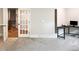 Bonus room featuring an open french door, carpeted floor, and a desk with a projector at 1218 Rogers Farm Rd, Wake Forest, NC 27587