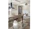 Bright dining room with rustic table, hardwood floors, and elegant lighting at 1218 Rogers Farm Rd, Wake Forest, NC 27587