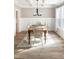 Dining room with wainscoting, hardwood floors, modern light fixture, and ample natural light at 1218 Rogers Farm Rd, Wake Forest, NC 27587