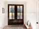 Welcoming entryway with decorative double doors, light hardwood floors, wainscotting, and a bench at 1218 Rogers Farm Rd, Wake Forest, NC 27587