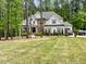 Beautiful two-story home featuring mixed brick and siding facade, well-manicured lawn and wooded background at 1218 Rogers Farm Rd, Wake Forest, NC 27587