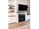 Stylish living room with modern fireplace, floating shelves, and built-in cabinets at 1218 Rogers Farm Rd, Wake Forest, NC 27587
