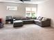 Expansive living room with a large sectional sofa, playroom, and natural light from the windows at 1218 Rogers Farm Rd, Wake Forest, NC 27587
