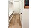 Mudroom area featuring wood flooring, a built-in bench with storage baskets, and a view to the hallway at 1218 Rogers Farm Rd, Wake Forest, NC 27587