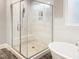Bathroom showcasing a glass-enclosed shower with marble-look tile, a bench, and built-in shelving at 1218 Rogers Farm Rd, Wake Forest, NC 27587