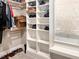 Walk-in closet with custom white shelving and organization, and a view to a window at 1218 Rogers Farm Rd, Wake Forest, NC 27587