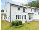 Backyard view featuring an exterior of the home, patio, and landscaped lawn at 1240 Gemfor St, Durham, NC 27703