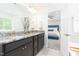 Well-appointed bathroom with a double vanity, granite countertops, and a view into the serene main bedroom at 1240 Gemfor St, Durham, NC 27703