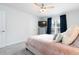 Bright bedroom with neutral walls, carpet, and a window with blue curtains for a touch of color at 1240 Gemfor St, Durham, NC 27703