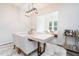 Bright dining area features a modern light fixture and adjacent living space, perfect for entertaining guests at 1240 Gemfor St, Durham, NC 27703