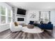 Bright living room featuring a fireplace, comfortable seating, and large windows at 1240 Gemfor St, Durham, NC 27703
