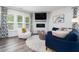 Cozy living room with modern furniture, fireplace, hardwood floors, and lots of natural light at 1240 Gemfor St, Durham, NC 27703