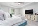 Bright and airy main bedroom offers ample space, a large window, and a stylish media console at 1240 Gemfor St, Durham, NC 27703