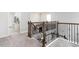 Elegant staircase with wrought iron railing and plush carpeting, leading to the upper level at 1240 Gemfor St, Durham, NC 27703