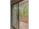 Balcony view through sliding glass doors, showcasing a scenic outdoor space with lush trees at 127 Finley Forest Dr, Chapel Hill, NC 27517