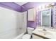 Cozy purple bathroom featuring a tub and shower with a vanity with mosaic tile backsplash at 127 Finley Forest Dr, Chapel Hill, NC 27517