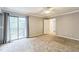 Bright bedroom with private balcony access, neutral carpet, and grey curtains at 127 Finley Forest Dr, Chapel Hill, NC 27517