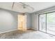 Bedroom with a ceiling fan and track lighting leading to a private balcony with sliding glass doors at 127 Finley Forest Dr, Chapel Hill, NC 27517