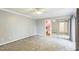Spacious bedroom with neutral carpet, a ceiling fan, and sliding mirror door closet that leads to a small bathroom at 127 Finley Forest Dr, Chapel Hill, NC 27517