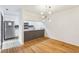 Dining area with hardwood flooring and view of the modern, open-concept kitchen at 127 Finley Forest Dr, Chapel Hill, NC 27517