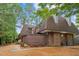 Charming home exterior with a brick facade and a private patio, complemented by mature trees at 127 Finley Forest Dr, Chapel Hill, NC 27517