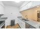 Renovated kitchen featuring stainless steel appliances, granite counters, hardwood floors and white cabinets at 127 Finley Forest Dr, Chapel Hill, NC 27517